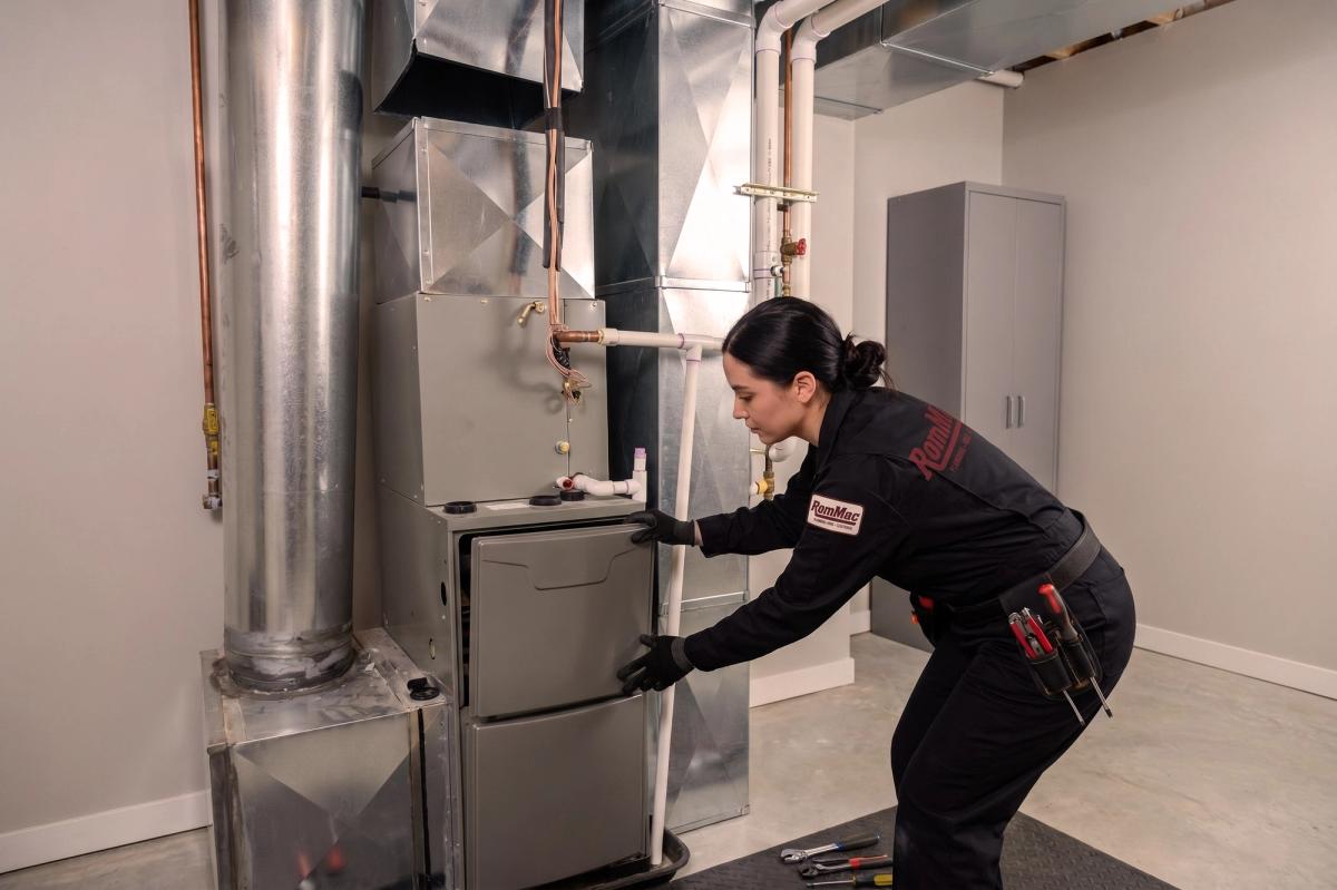 RomMac technician taking apart a furnace