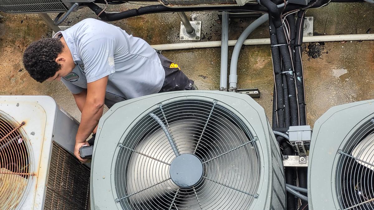 RomMac technician installing new AC units
