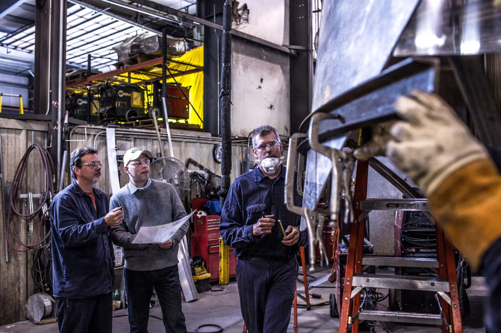 Amthor team reviewing custom tanker truck plans on the shop floor