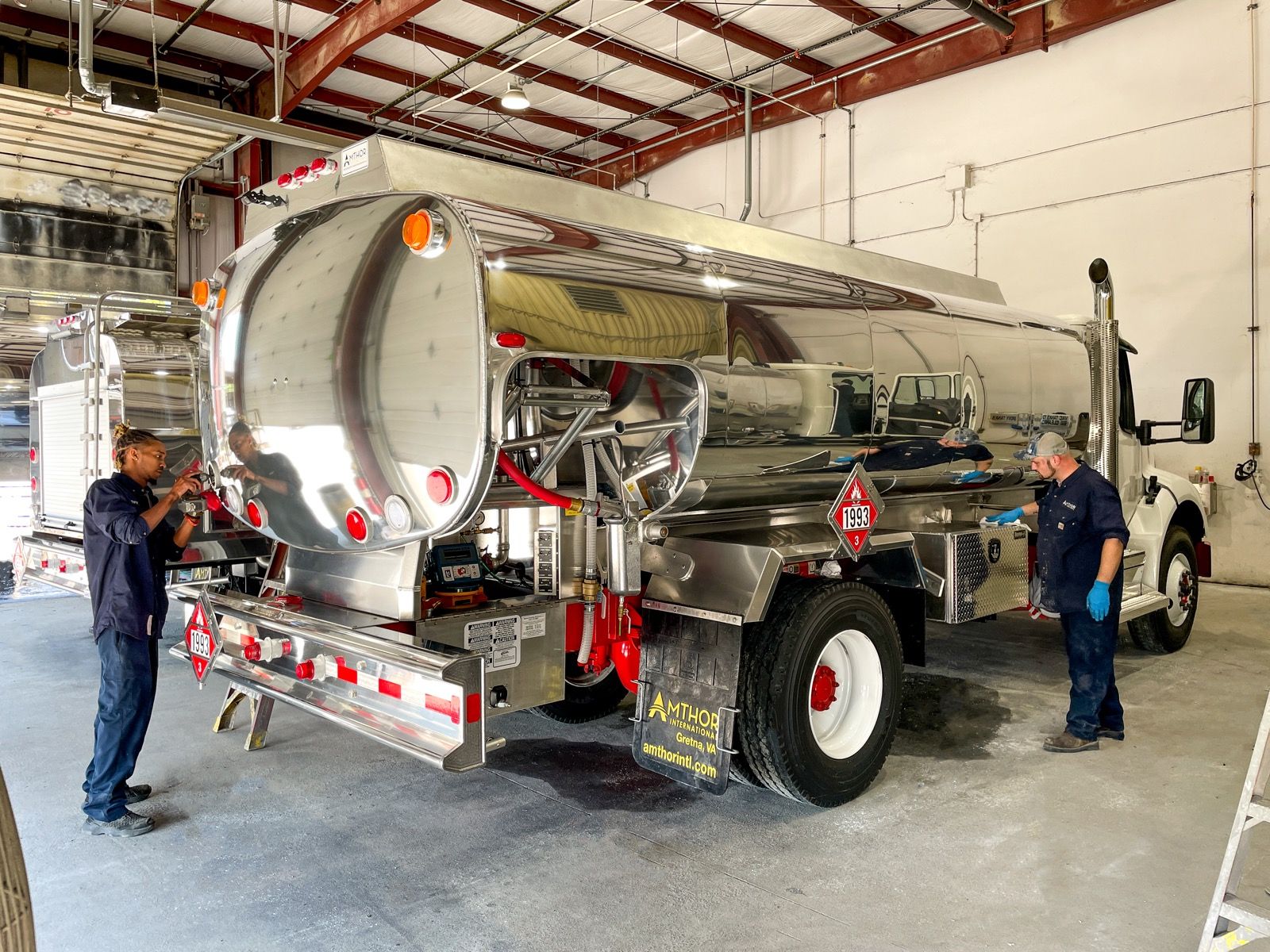 Amthor craftsman finishing a polished stainless steel tanker shell