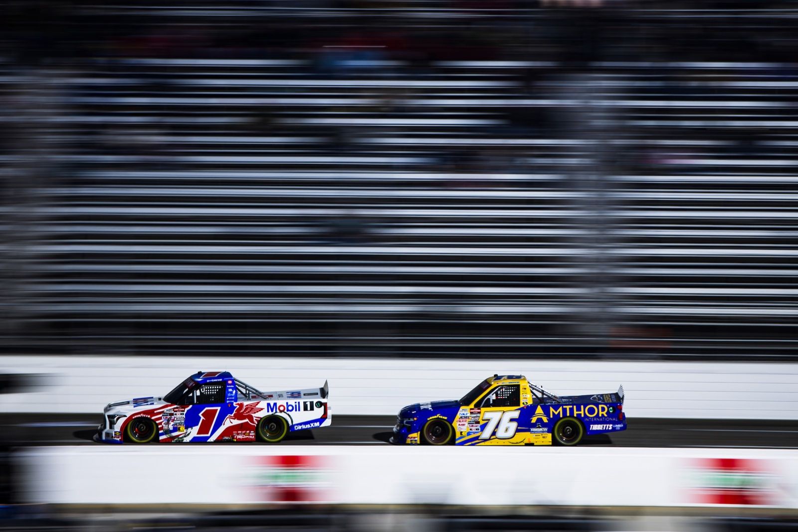 The #76 Amthor truck racing the #1 Mobil 1 truck in the NASCAR Craftsman Truck Series