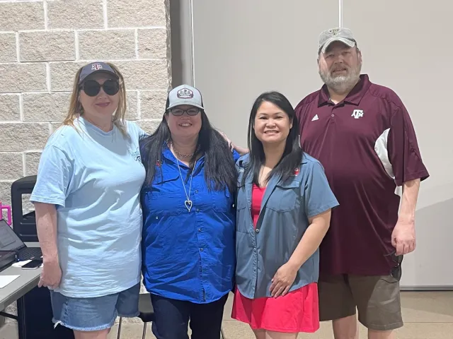 Four Gene Potts Memorial community members pose together at an event.