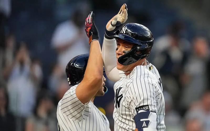 Aaron Judge celebrates at home plate as Trent Grisham rounds the bases after his ninth-inning game-tying home run against the Angels at Yankee Stadium.