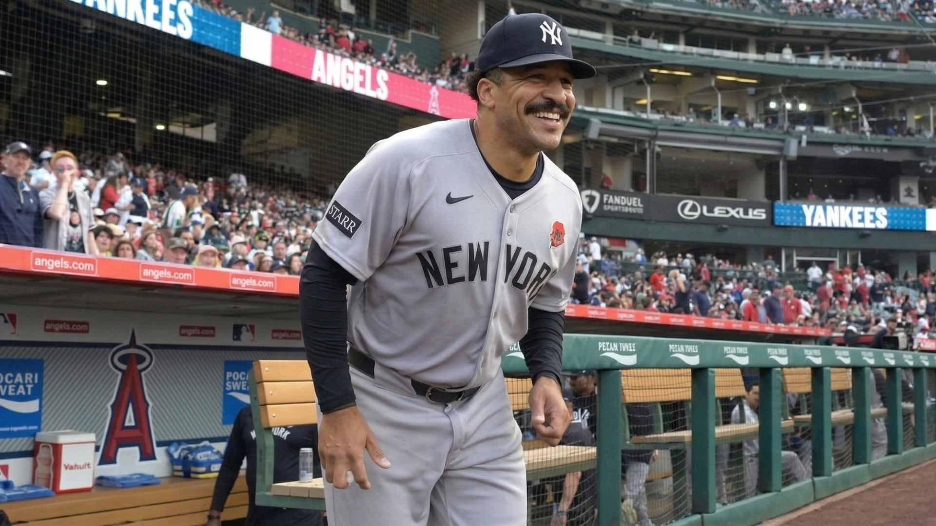 Trent Grisham tracks a fly ball in center field at Yankee Stadium as fans look on.