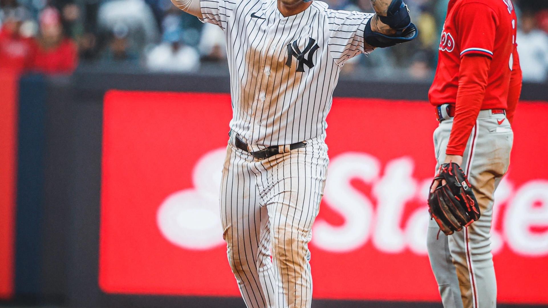 Gleyber Torres puts up both his hands after hitting a double.