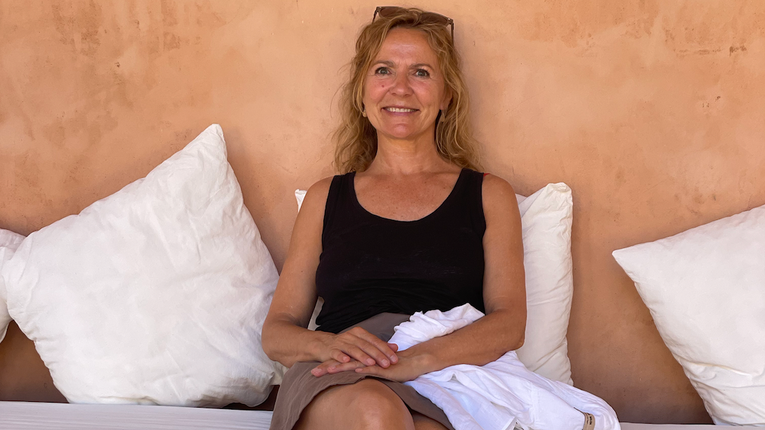 a black board with the words `` whatever it takes '' written on it is hanging on a white wall .