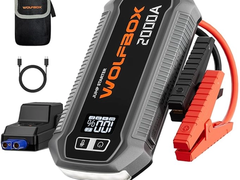 WOLFBOX 2000A jump starter power pack with LCD display, jump leads, USB charging ports and emergency LED light.