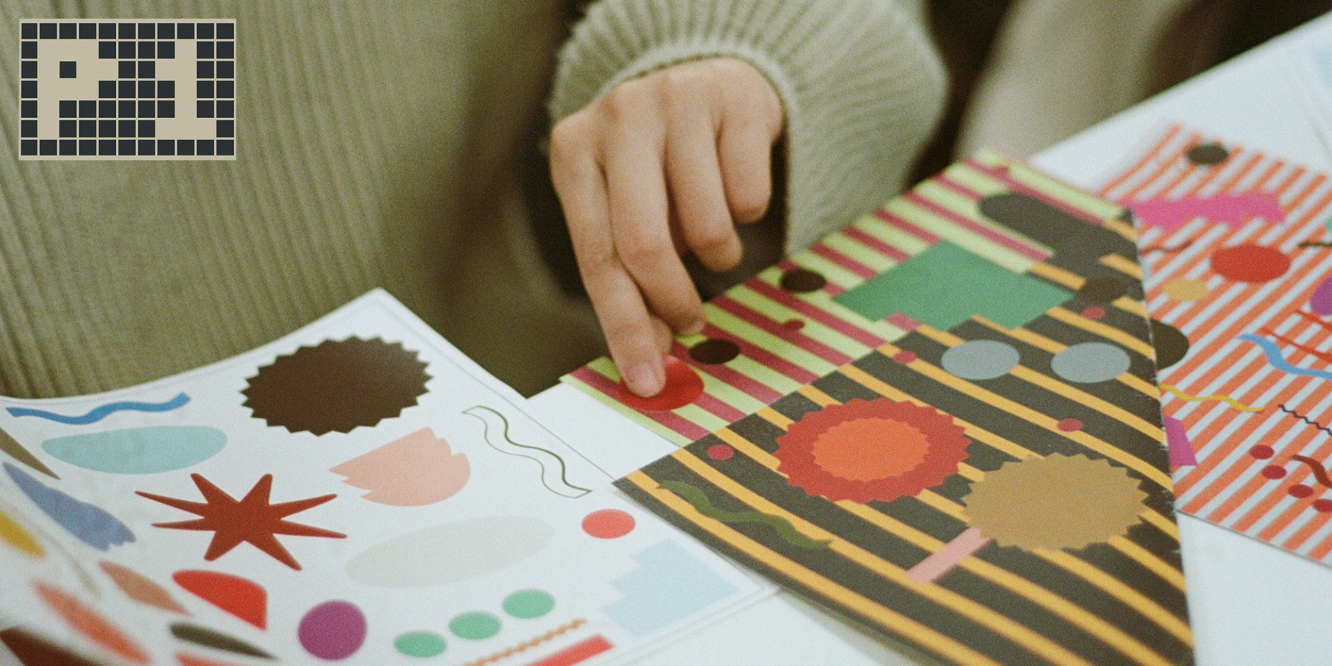 Photo of student working with stickers in various colours and shapes