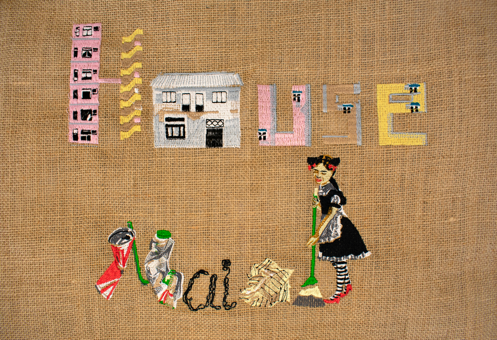 Digitally embroidered motifs which makes up the letters of 'House Wife' on a jute bag.