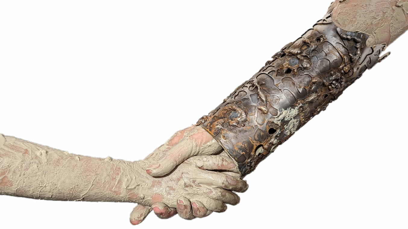 Photograph of shaking hands covered in mud, one with a metal forearm gauntlet