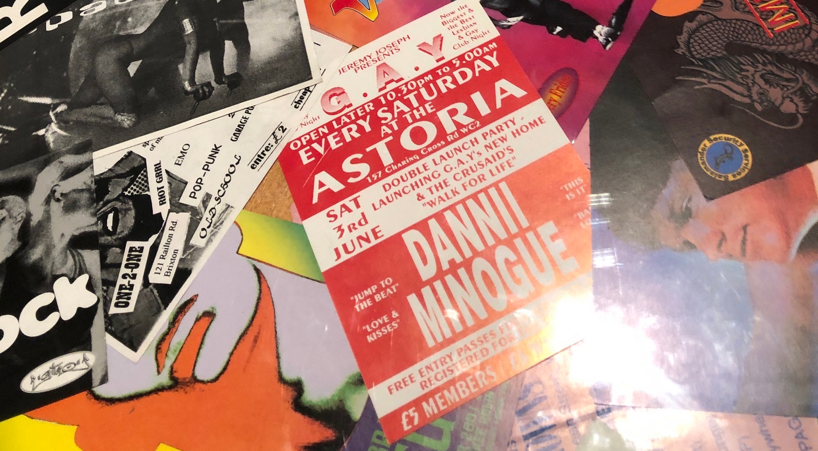A collage of queer nightlife posters under a vitrine. Dannii Minogue's name is prominent