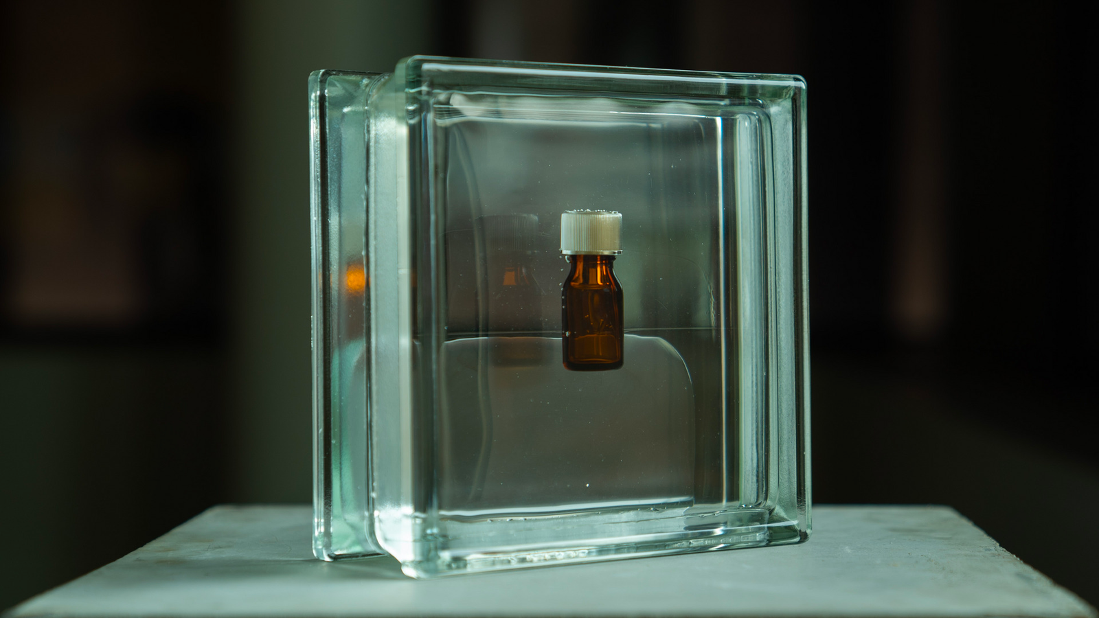 A bottle of poppers encased in an architectural glass block.