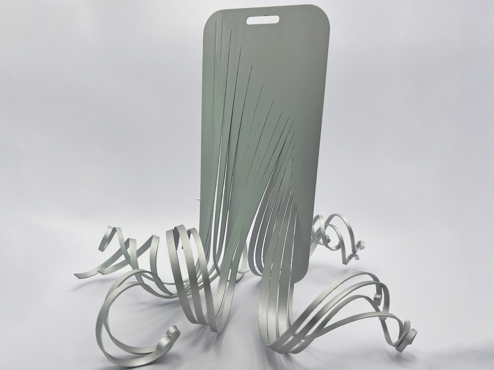 Smartphone shaped aluminium object which turns into a fluid, octopus-like shape.