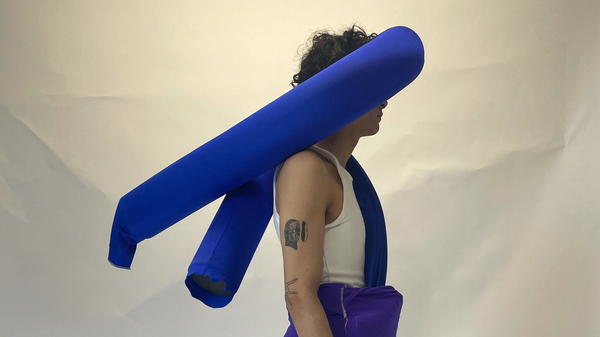 Photo of a man with a blue fabric tube wrapped around his face