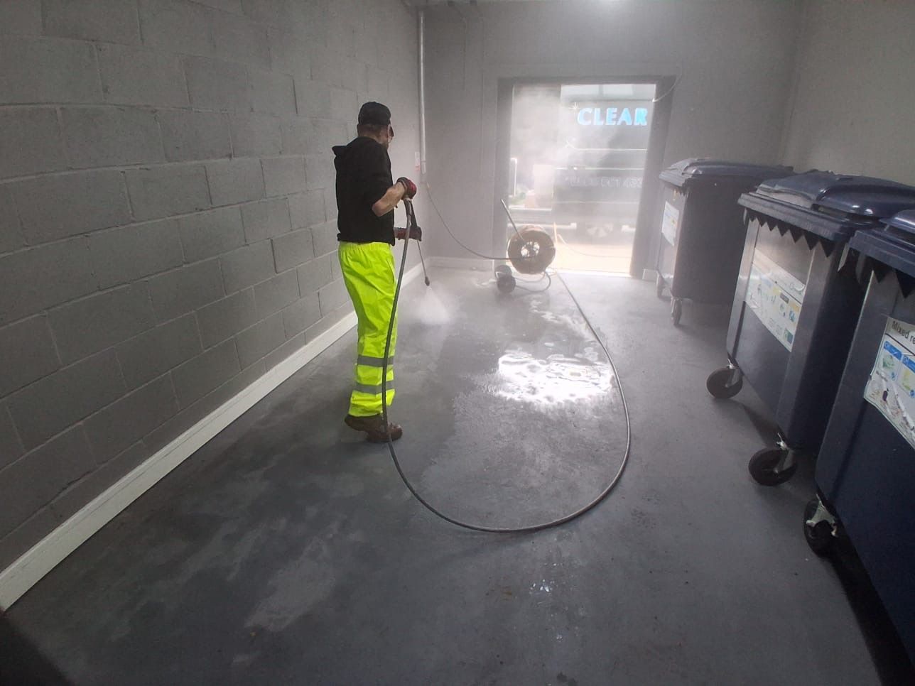 Bin store being jet washed and disinfected