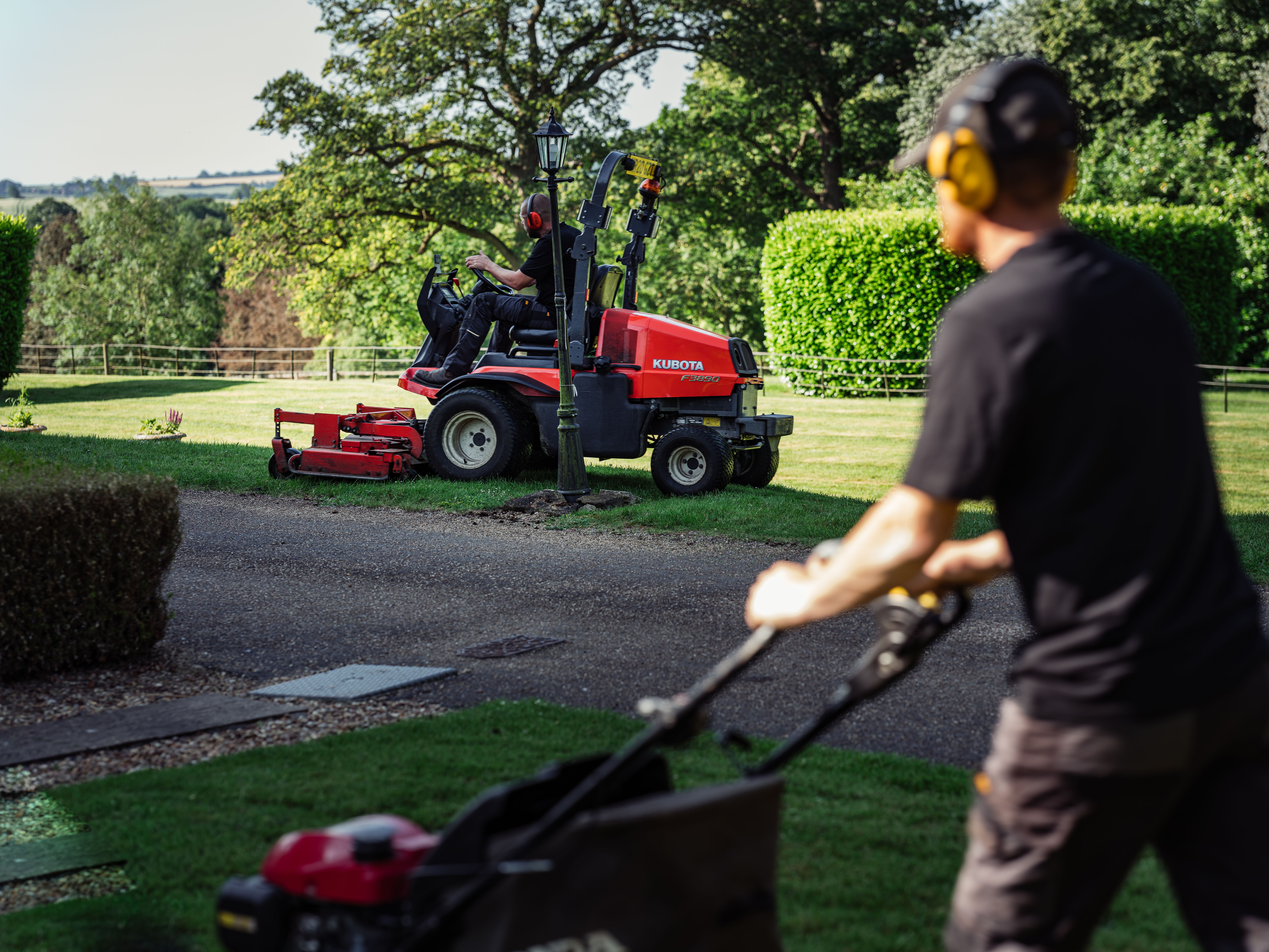 Operative mowing communal grounds with a ride-on mower