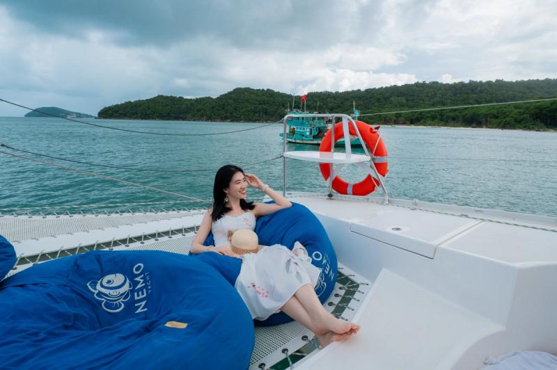Bow seating and a lifebuoy on a catamaran at sea