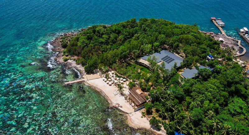 Aerial view of wooded shoreline and shallow water in the Hon Xuong collection