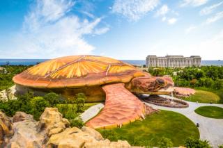 Closer aerial view of the turtle-shaped aquarium and surrounding gardens