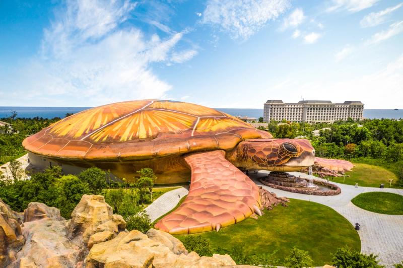 Closer aerial view of the turtle-shaped aquarium and surrounding gardens