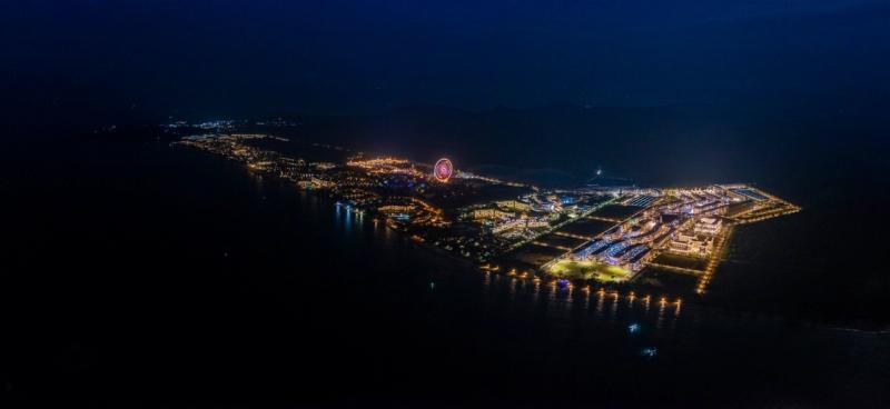 The illuminated Phu Quoc United Center complex and coastline at night