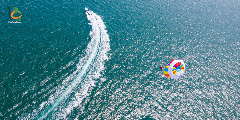 A boat towing a colourful parasail off Sao Beach