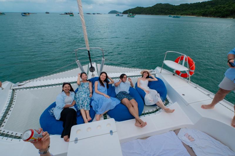 Passengers seated together at the bow of a catamaran