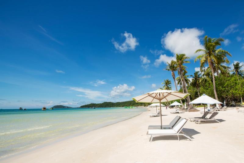 Sao Beach shoreline with white loungers and umbrellas