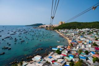 Cable-car lines above a harbour filled with fishing boats
