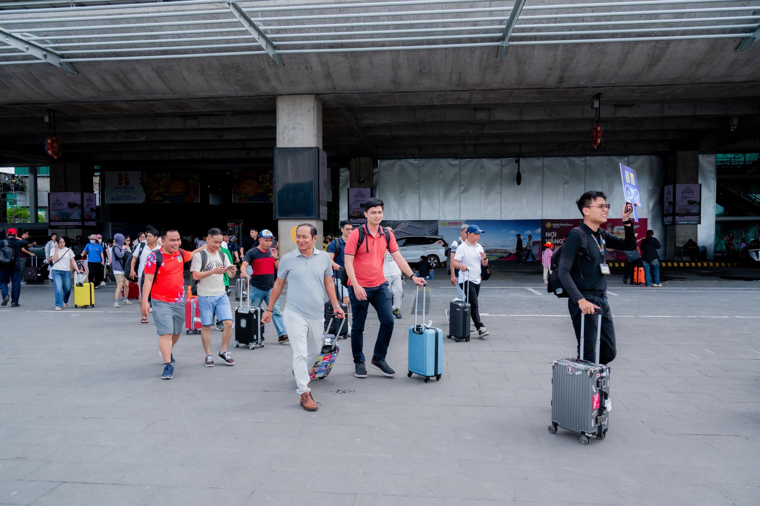 Travelers with luggage outside the airport terminal