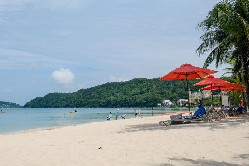 Red umbrellas and beach seating on Khem Beach