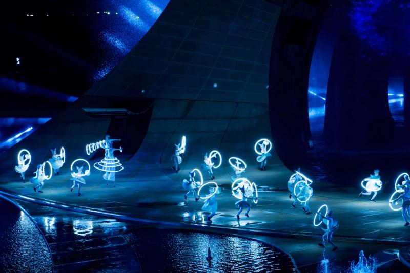 Hoop performers across the Kiss of the Sea stage; the ensemble is one part of the wider water-stage production.