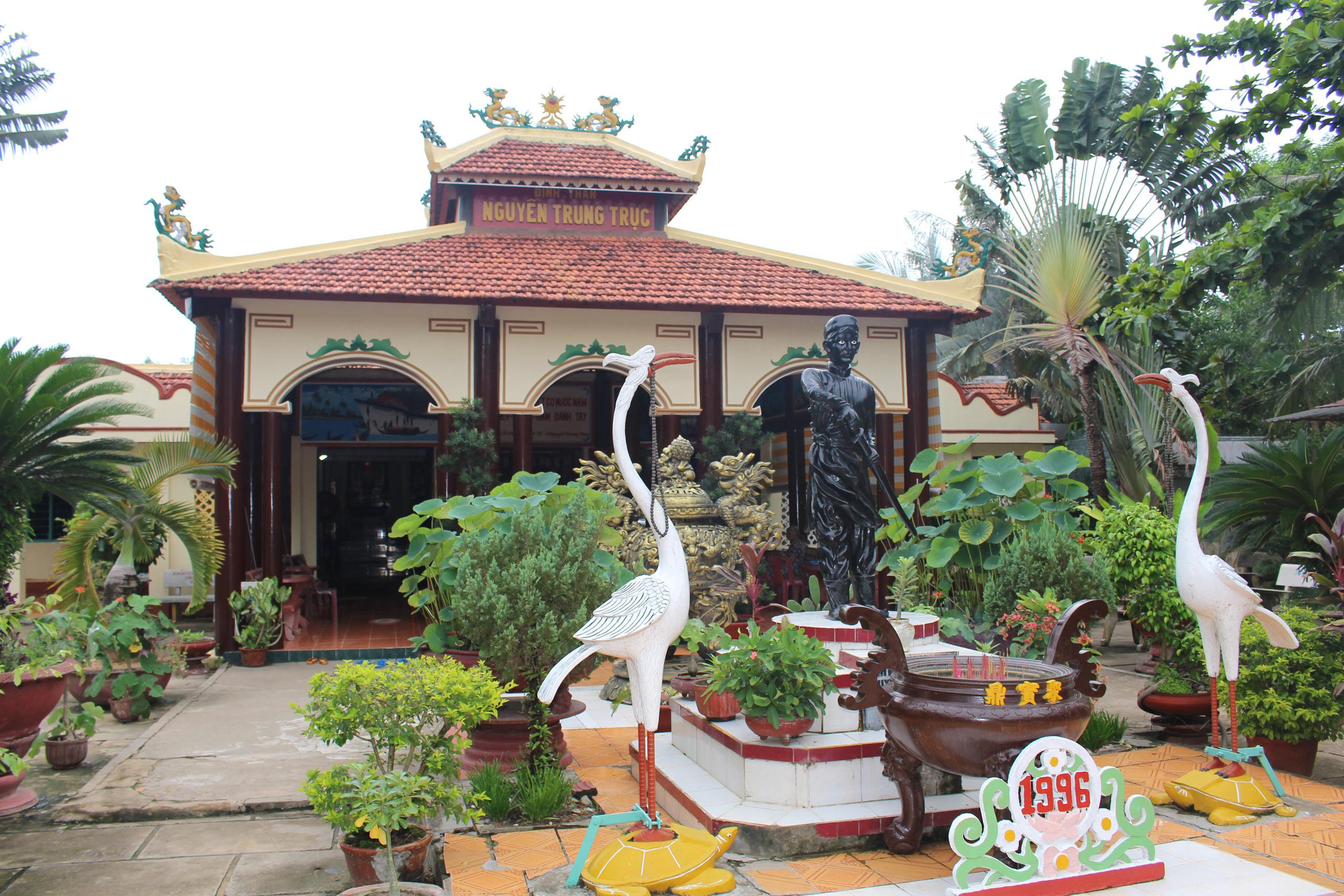 Nguyen Trung Truc statue and crane sculptures in the temple courtyard