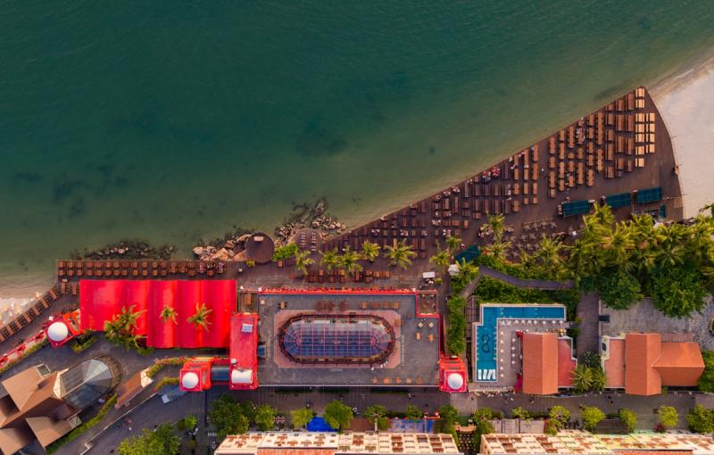 Red-roofed Sun Bavaria building and waterfront dining terrace from above