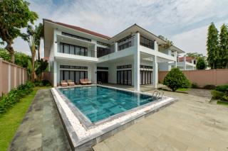 A modern villa beside a rectangular pool