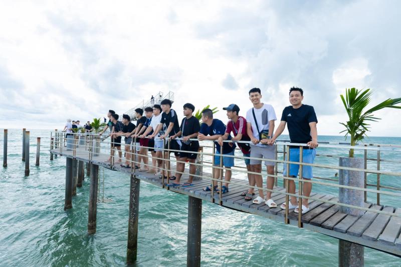 A group on the sea-facing pier at Xin Chao