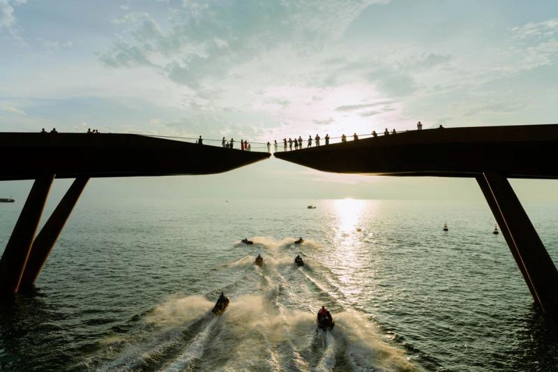 Jet skis in formation beneath Kiss Bridge