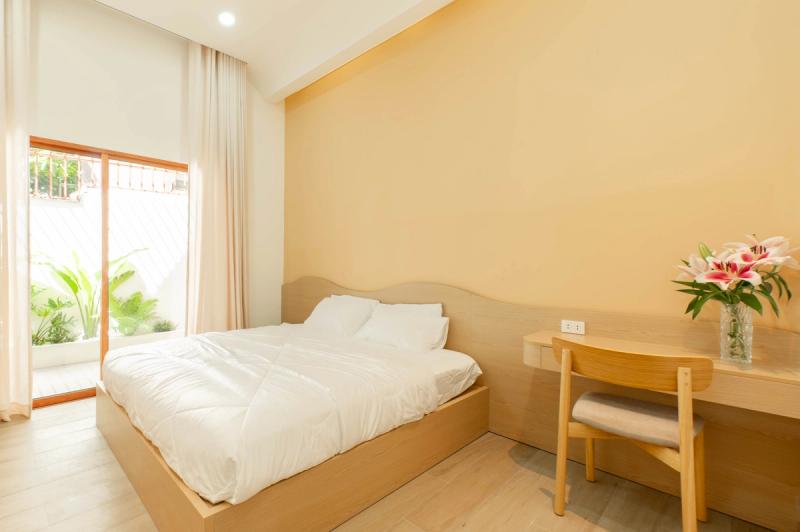 A compact bedroom with pale wooden furniture