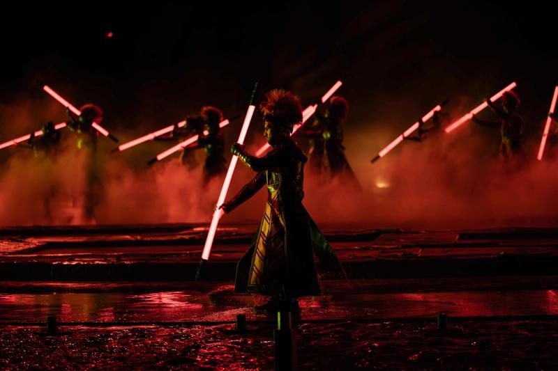 Performers with illuminated staffs at Kiss of the Sea, distinct from the separately named Symphony of the Sea.