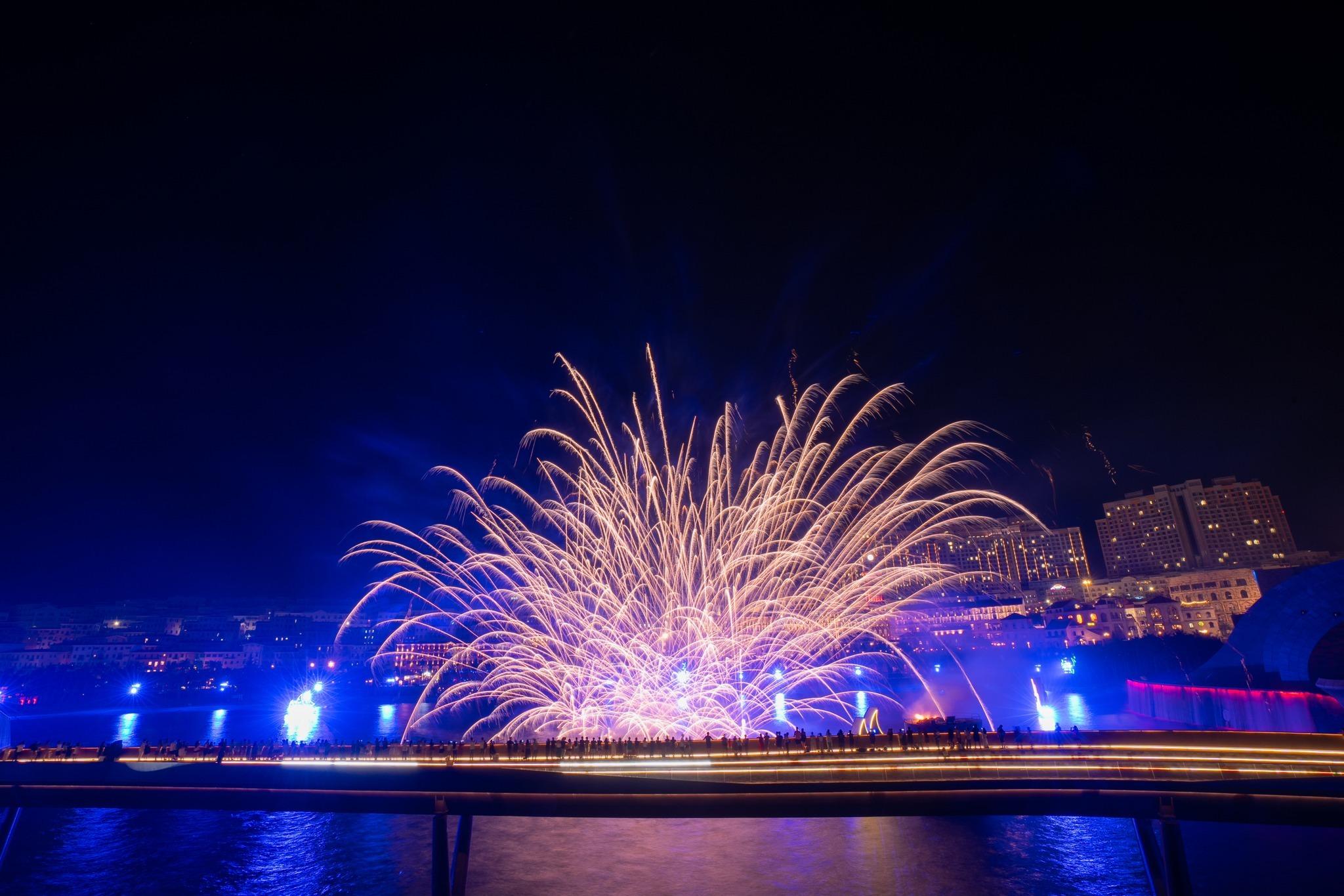 A fan of fireworks over the Symphony of the Sea waterfront