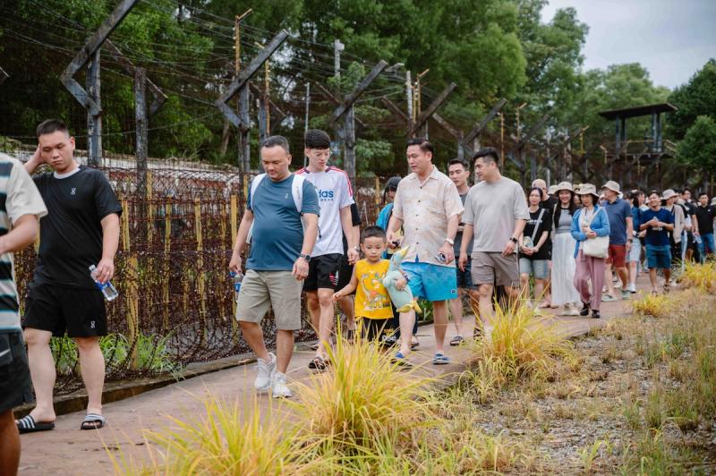 Visitors walking beside fences at the prison site