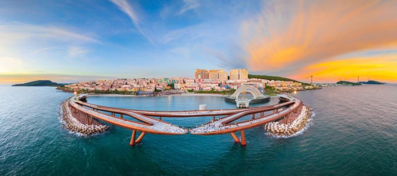 Kiss Bridge and the Sunset Town waterfront at sunset