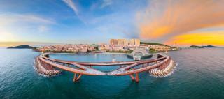 Kiss Bridge and the Sunset Town waterfront at sunset
