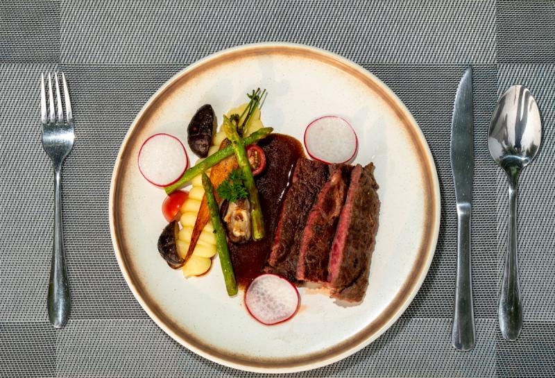 Sliced steak and vegetables photographed from above