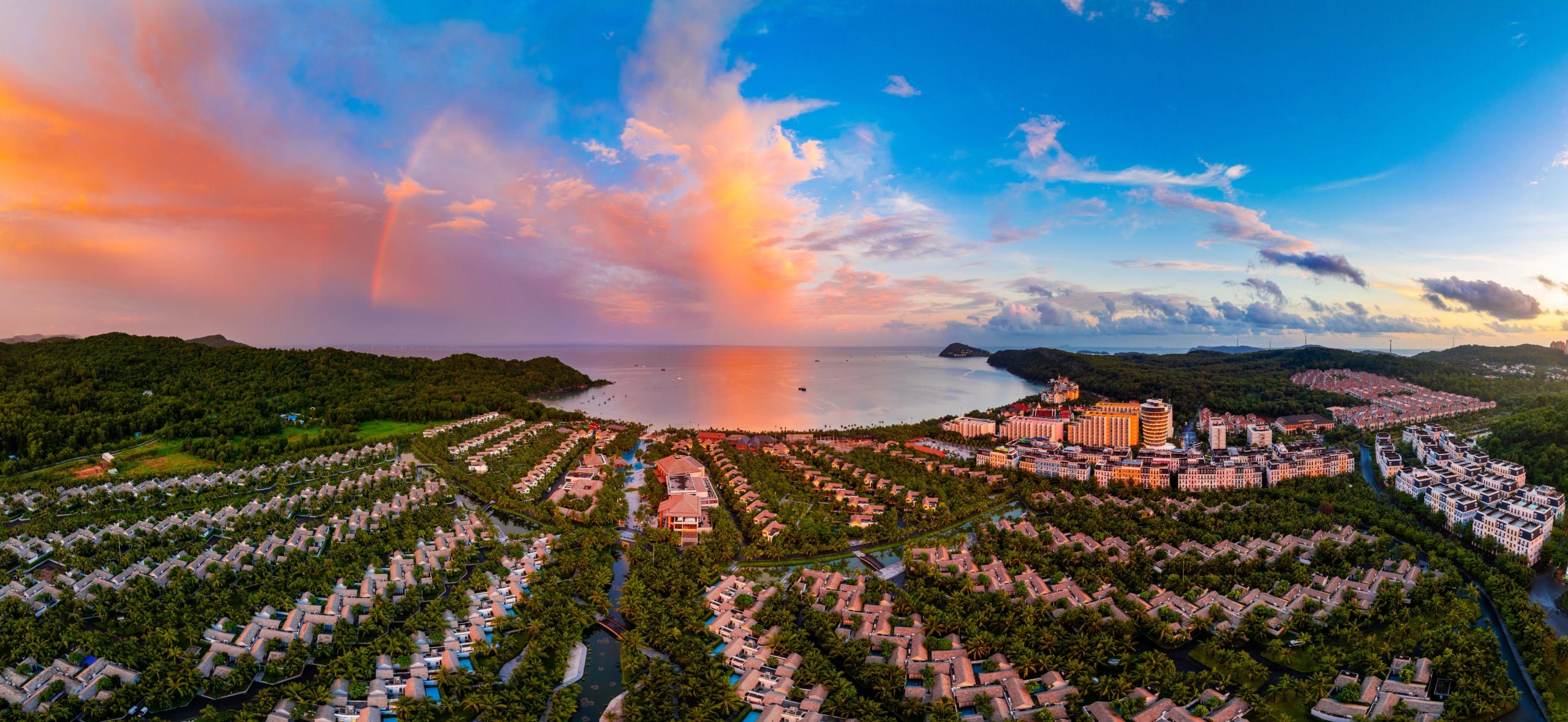 A coastal resort beneath a colourful sunset