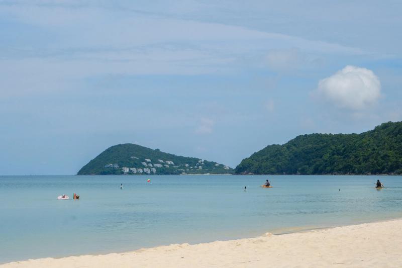 Khem Beach shoreline facing wooded headlands across the bay