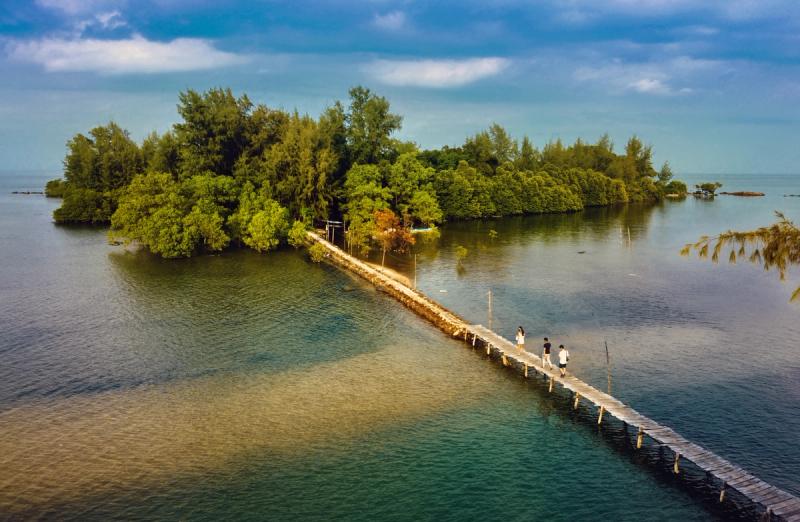 A footbridge and wooded shoreline in the Hon Mot collection