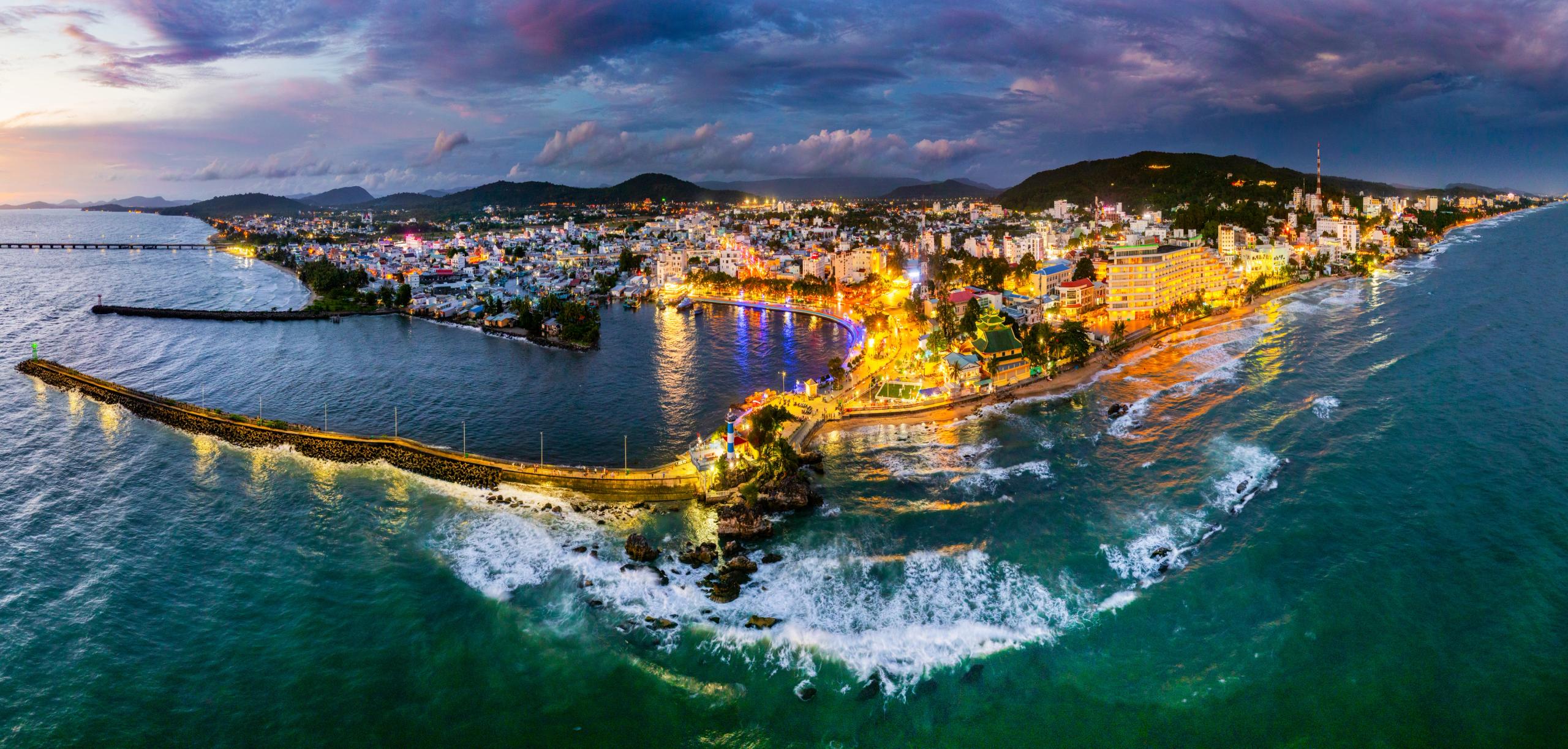 Dinh Cậu and the harbour illuminated at dusk