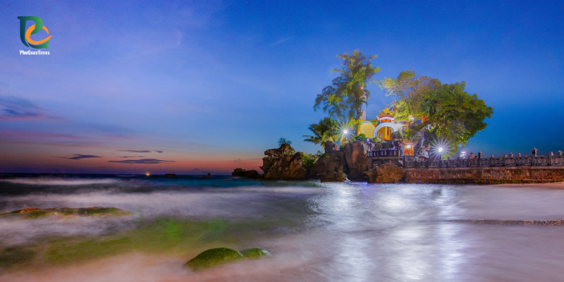 Dinh Cau shrine and its rocky shore at dusk