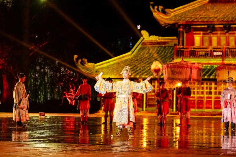 Costumed performers beneath the illuminated tiled gateway at Quintessence of Vietnam